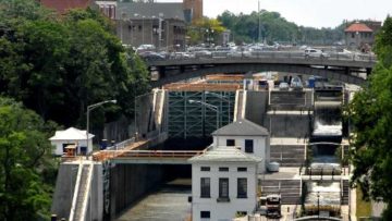 Erie Canal locks in downtown Lockport, N.Y., seen from above with a bridge crossing behind them
