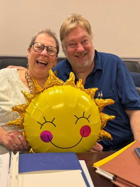 Two NYCOG members holding a sun balloon during Sunshine Week in Albany